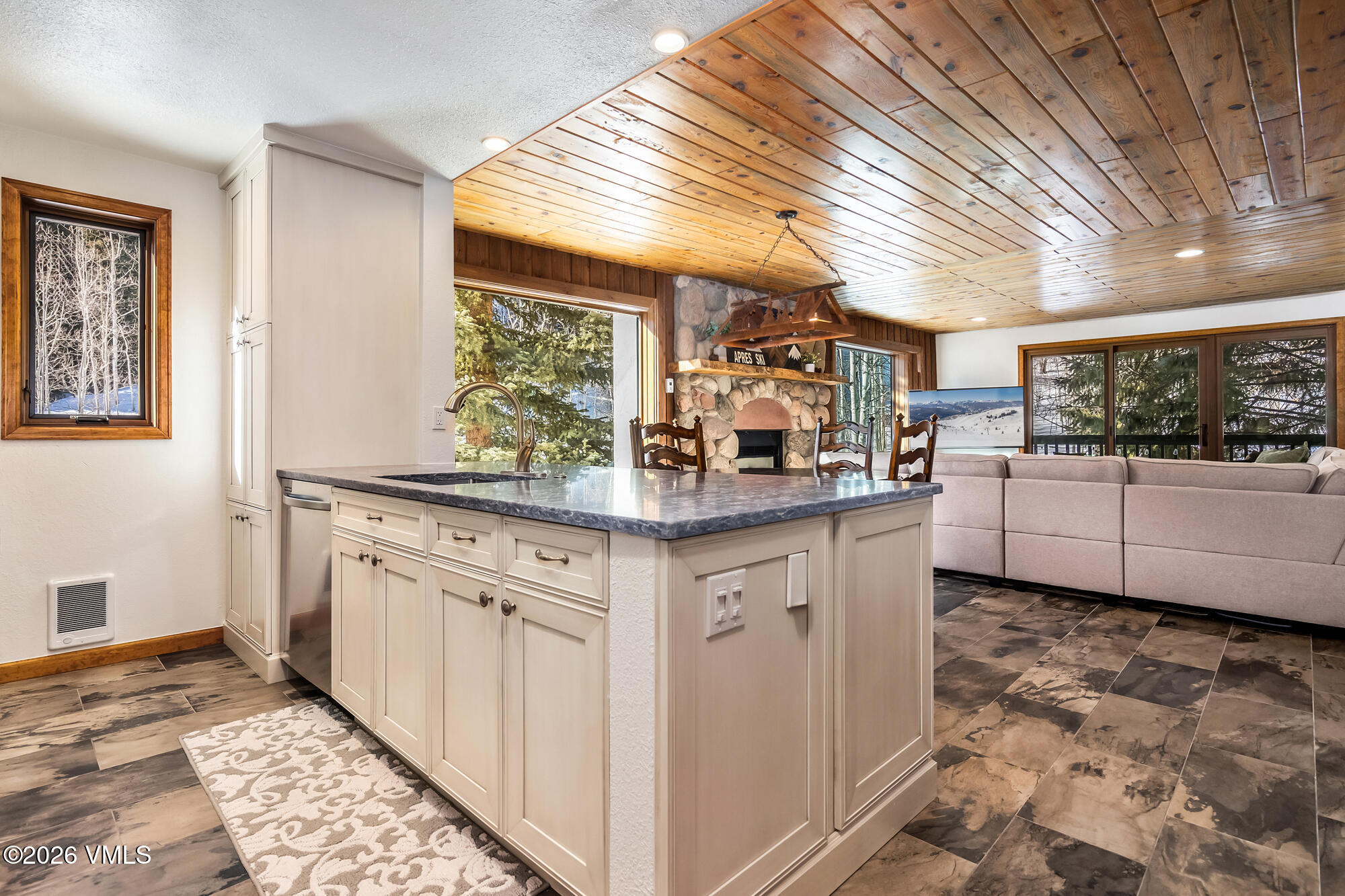 4470 Timber Falls Court, Unit 1405 Vail, CO 81657 - Photo 9 of 35 a kitchen with granite countertop a sink and cabinets