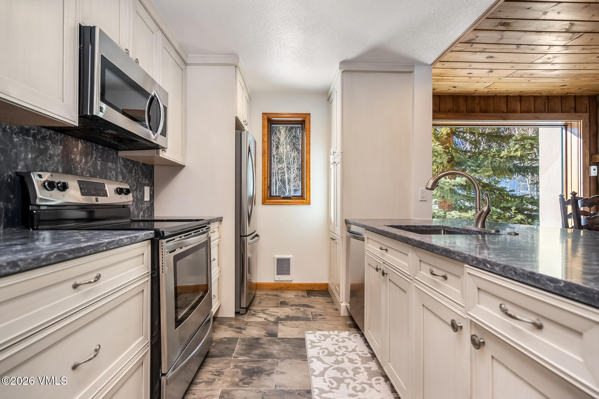 4470 Timber Falls Court, Unit 1405 Vail, CO 81657 - Photo 10 of 35 a kitchen with stainless steel appliances granite countertop a stove and a sink