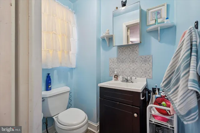 a bathroom with a sink toilet and vanity