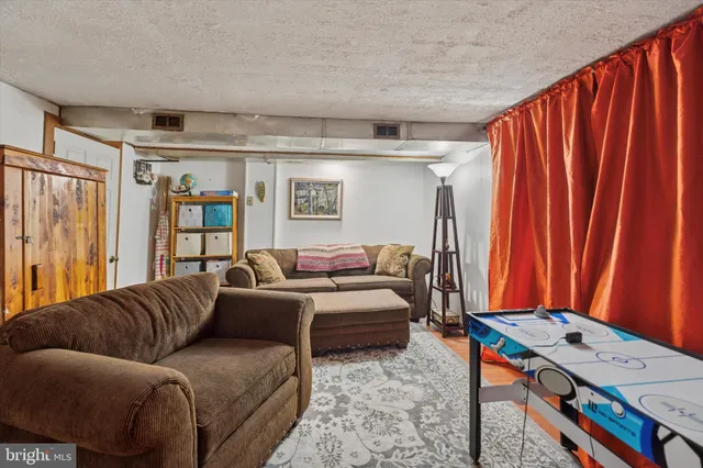 a living room with furniture a table and a flat screen tv