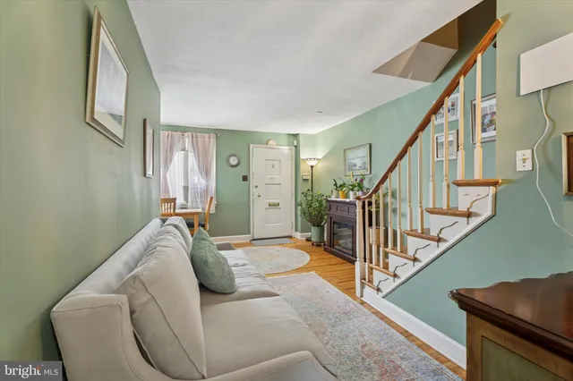 a living room with furniture and stairs