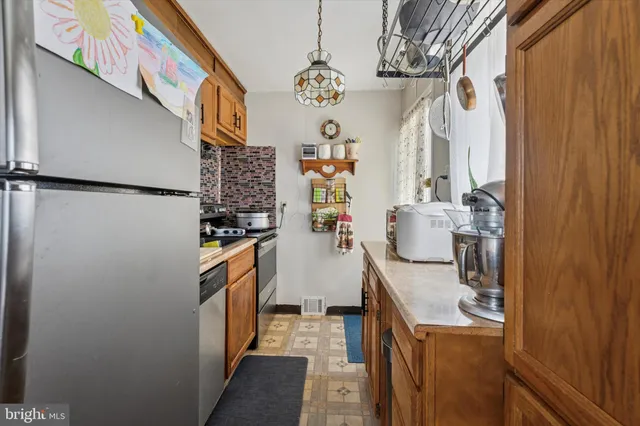 a kitchen with a refrigerator and a stove