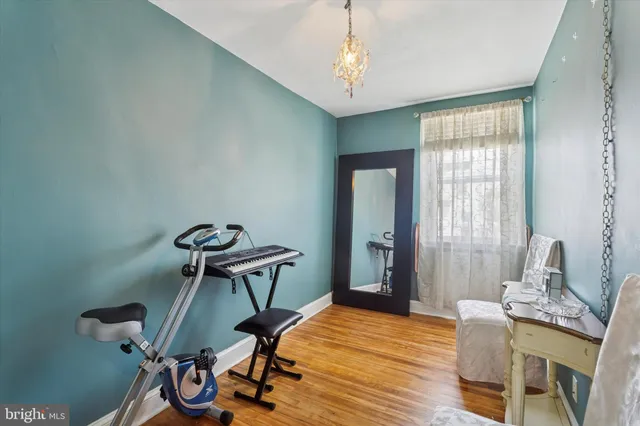 a view of a room with furniture and wooden floor