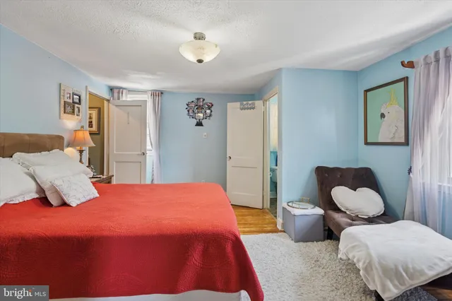 a bedroom with a bed and a couch