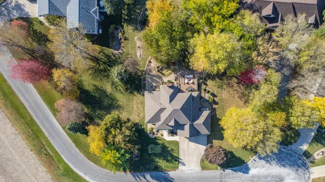 an aerial view of a house with a yard
