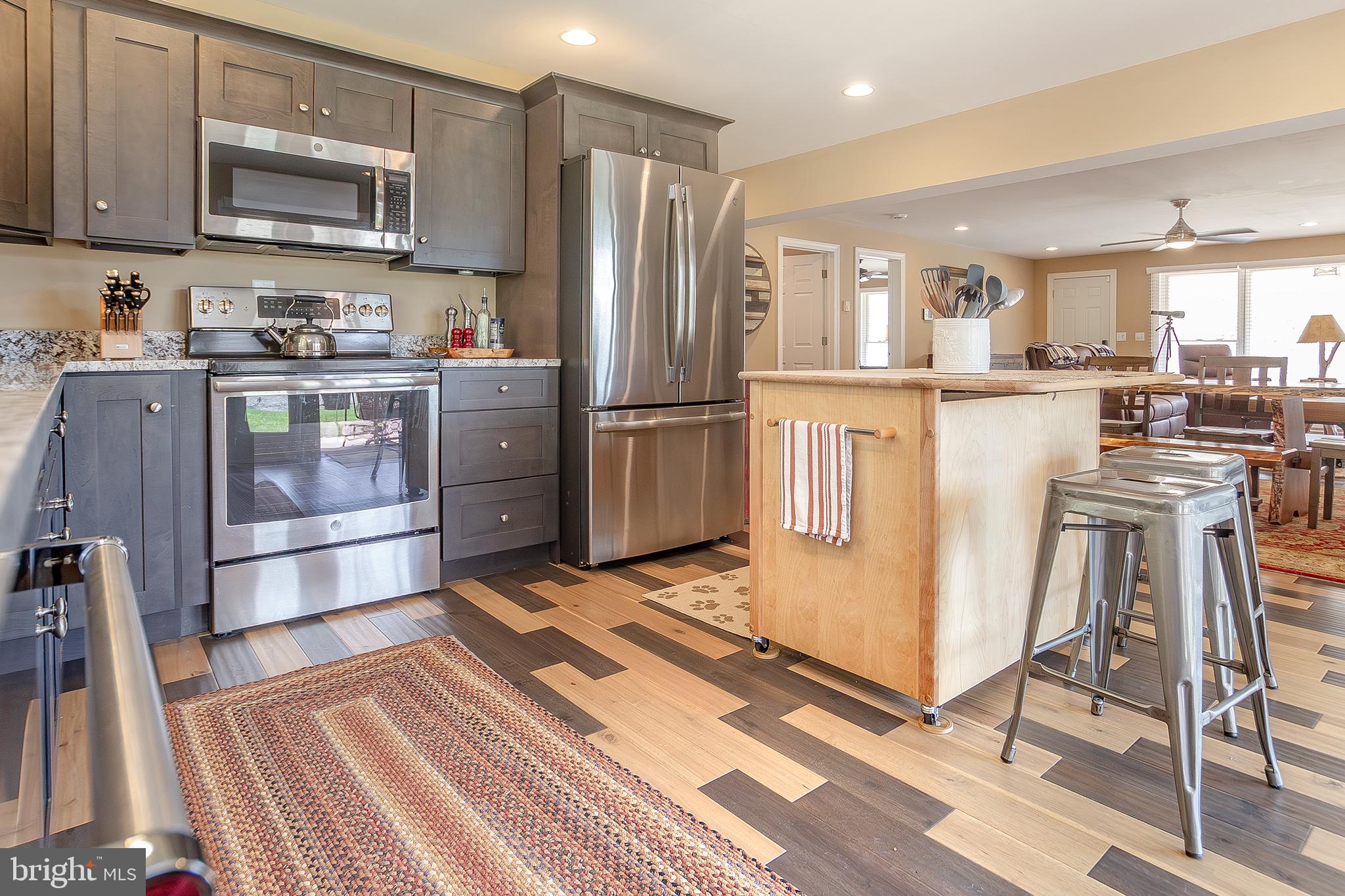 11907 Colyer Lane Shade Gap, PA 17255 - Photo 6 of 87 a kitchen with stainless steel appliances granite countertop a refrigerator a stove a sink and a stove with wooden floor