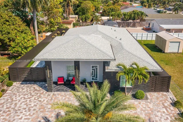 a view of a patio with table and chairs potted plants