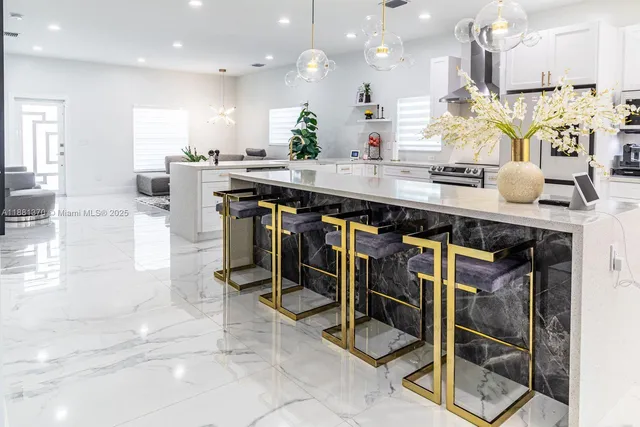 a kitchen with kitchen island granite countertop a table and chairs in it