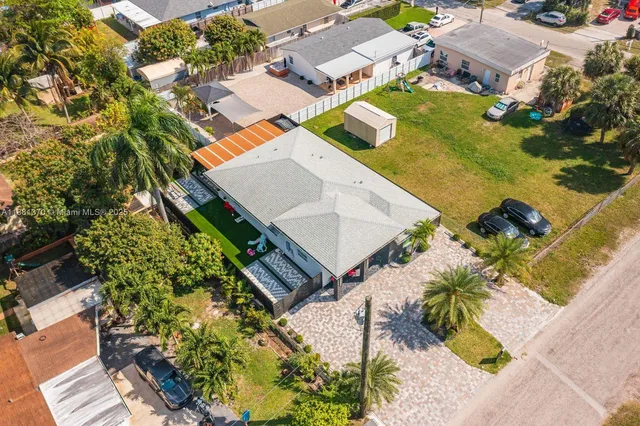 an aerial view of a house with a garden and swimming pool