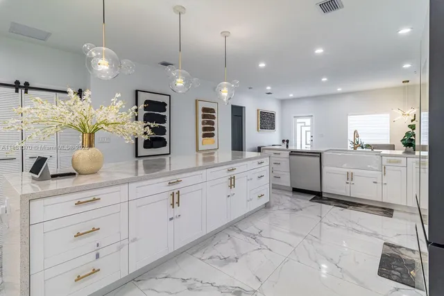 a large white kitchen with lots of counter space