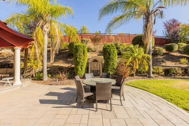 a view of a swimming pool with a chair and tables
