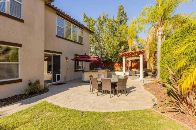 a view of a patio with table and chairs and potted plants