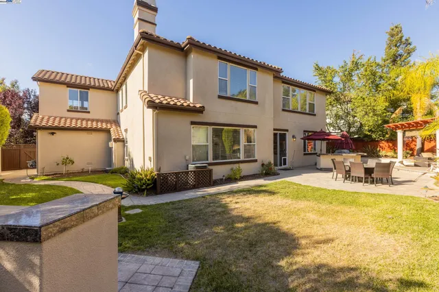 a view of a house with swimming pool and sitting area