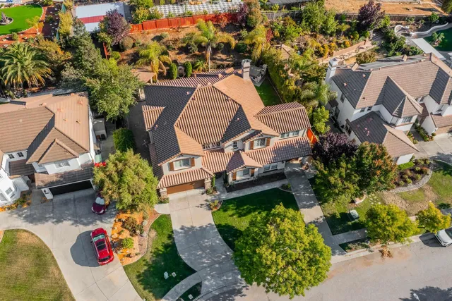 an aerial view of a house with a yard and garden