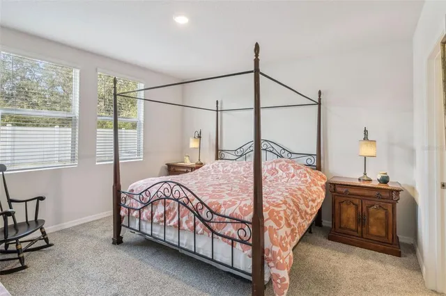 a bed sitting in a bedroom next to a window