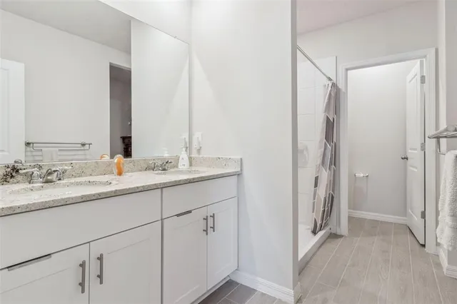 a bathroom with a double vanity sink and mirror