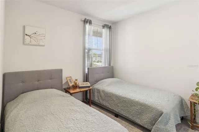 a bedroom with two beds and a window