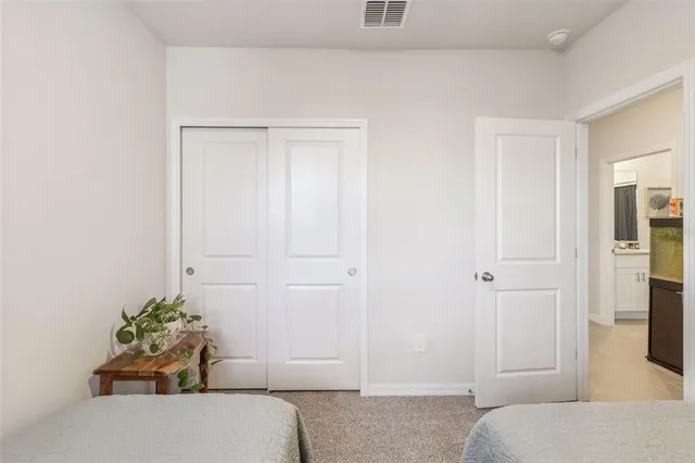 a bedroom with a bed and hallway