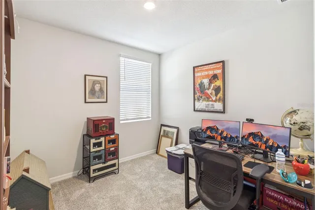 a view of a workspace with furniture and a window