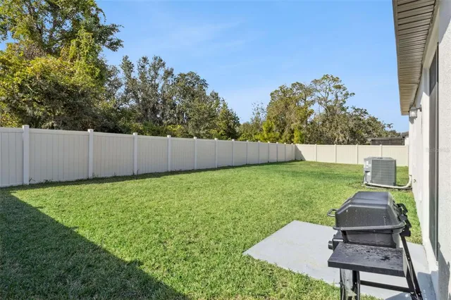 a view of backyard with seating area