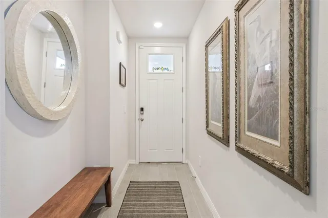 a view of a bathroom with shower and mirror