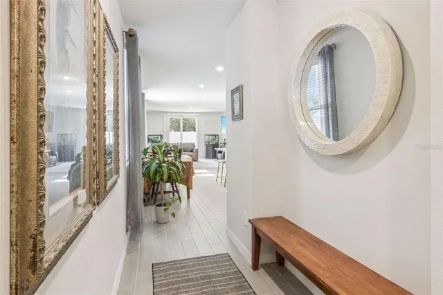 a hallway with a dining table and a chandelier