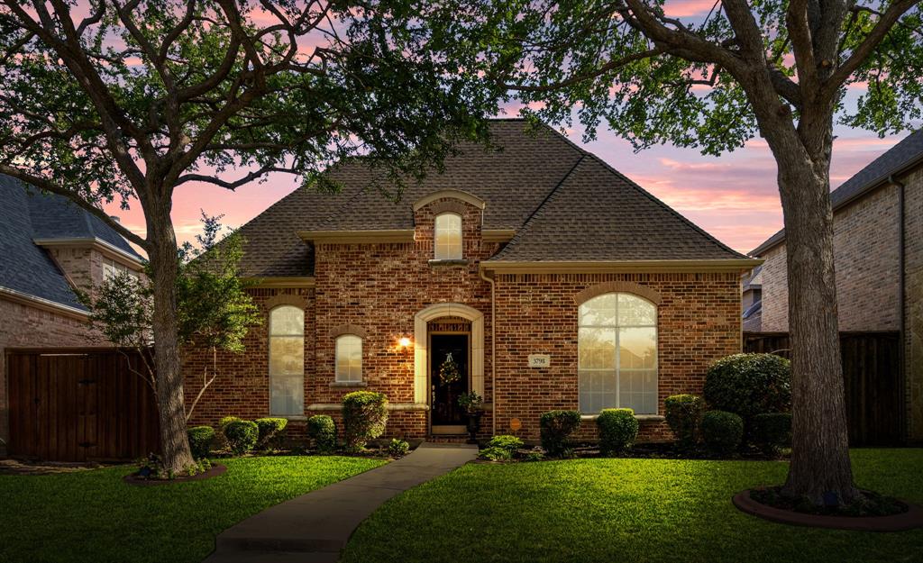 a front view of a house with a garden and plants