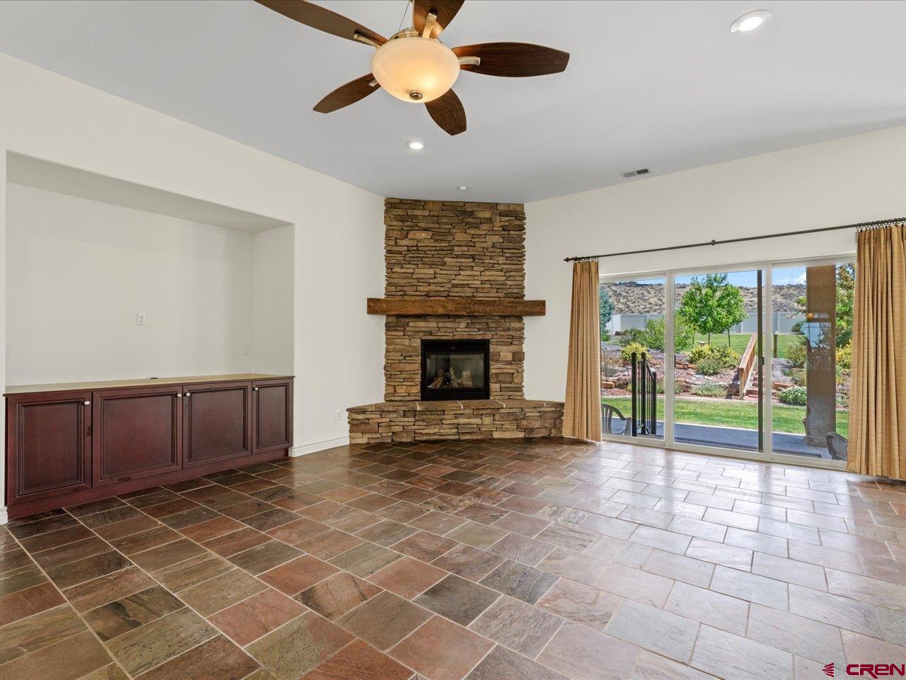 2001 Constitution Loop Montrose, CO 81401 - Photo 12 of 40 a view of an empty room with a fireplace and a window