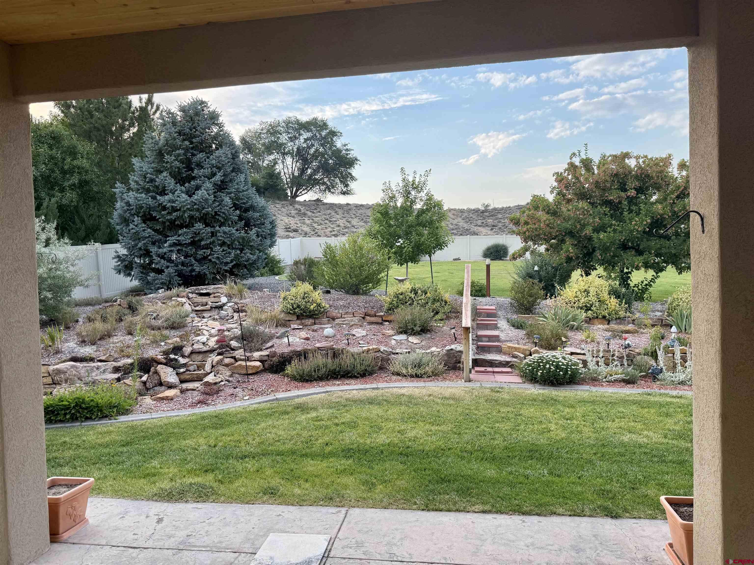 2001 Constitution Loop Montrose, CO 81401 - Photo 36 of 40 a view of backyard with plants and outdoor seating