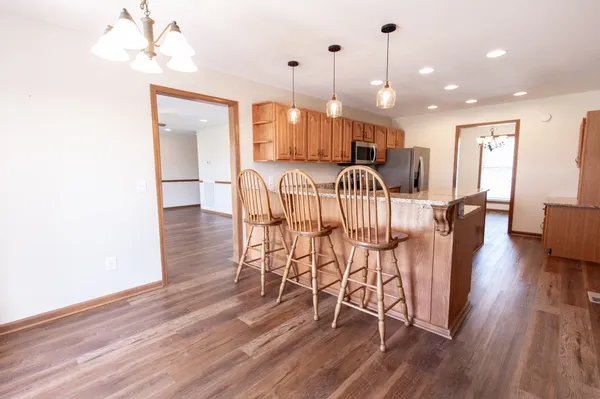 an empty room with windows and ceiling fan
