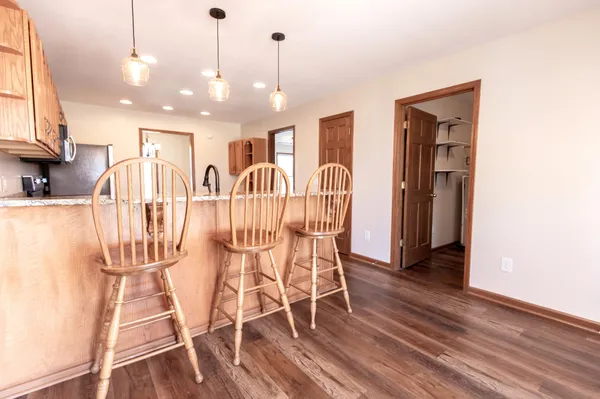 an empty room with wooden floor fireplace and a window