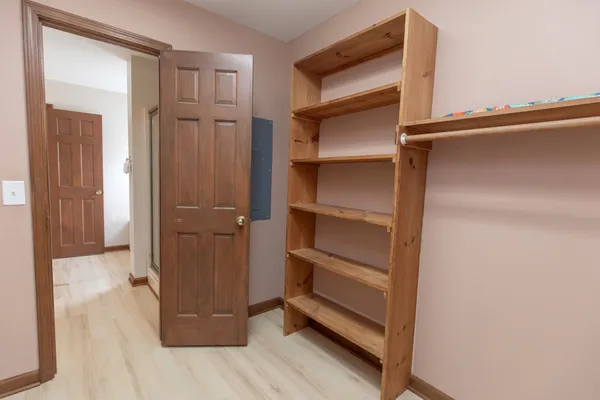 a view of a house with a big yard and large trees