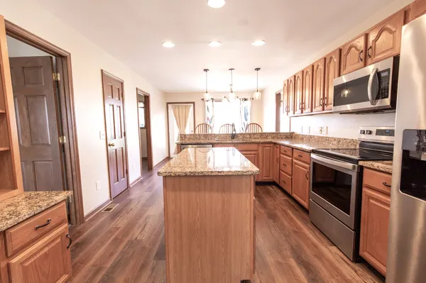 a view of a dining room with furniture and wooden floor