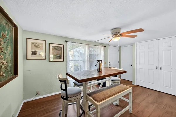 a view of a workspace with furniture and wooden floor