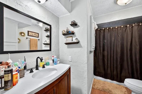 a bathroom with a sink vanity and mirror
