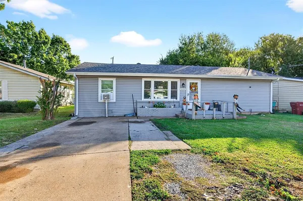 a front view of house with yard and outdoor seating