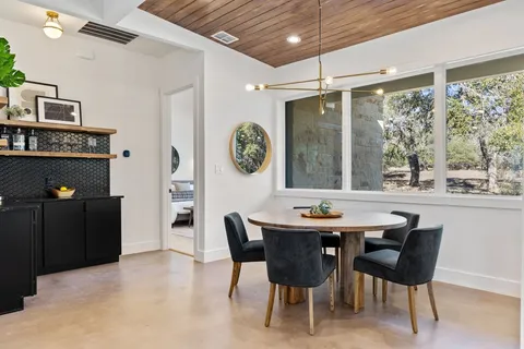 a view of a dining room with furniture and a large window