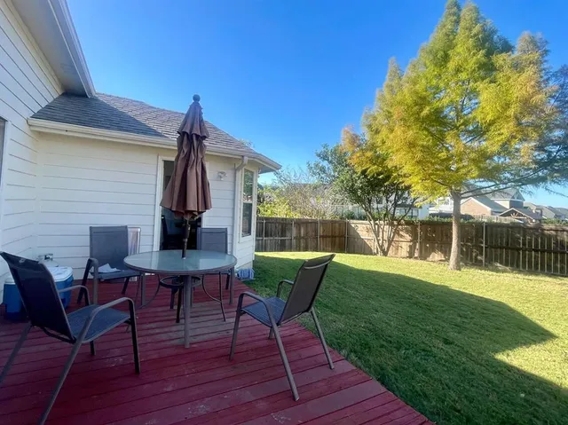 a view of swimming pool with a table and chairs