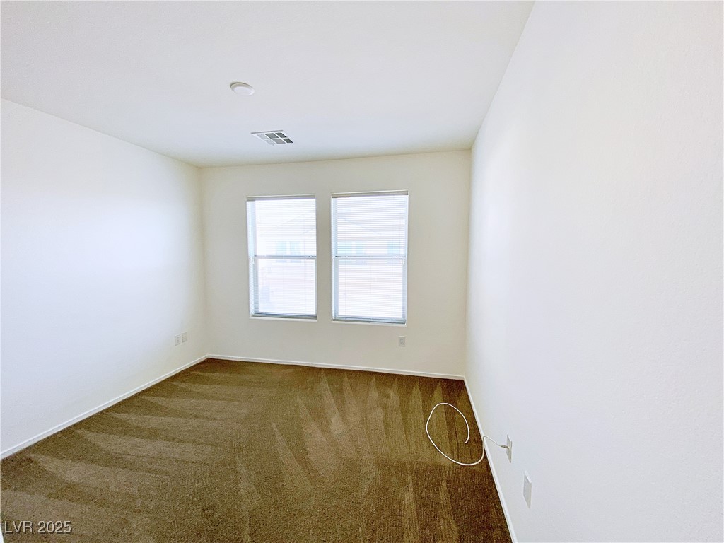 9335 Indian Corn Court, Unit 101 Las Vegas, NV 89178 - Photo 15 of 18 Carpeted empty room with baseboards