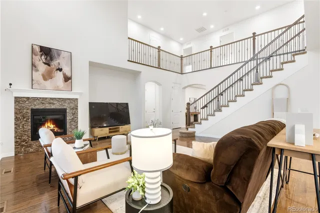 a open dining room with furniture a chandelier a kitchen view and a potted plant