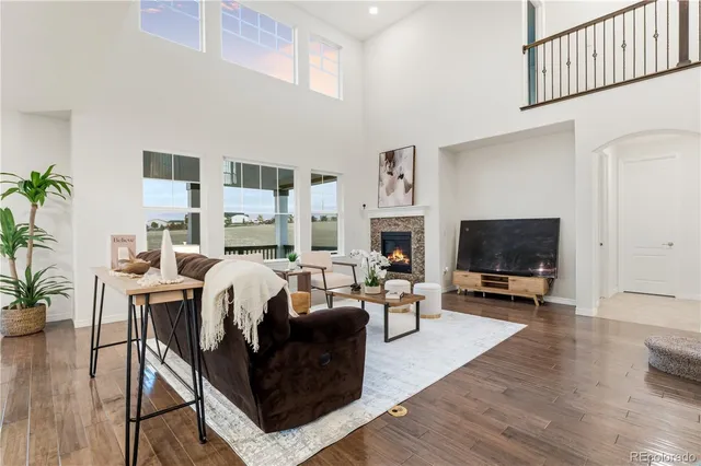 a living room with furniture and a table with wooden floor