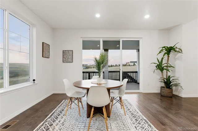 a bathroom with a granite countertop sink a toilet and a mirror