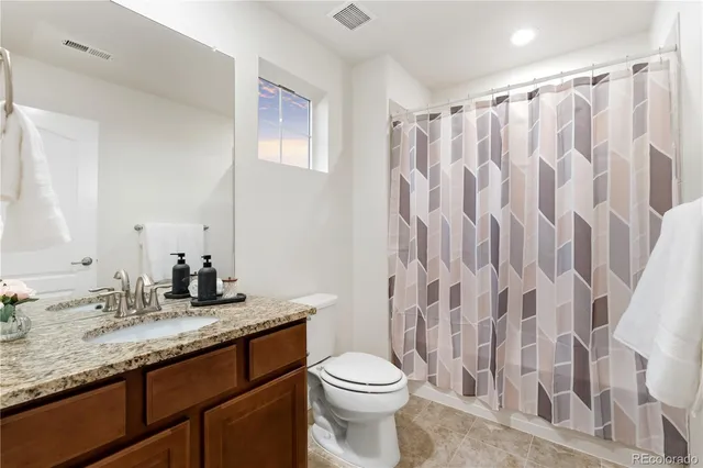 an aerial view of a house with a garden and lake view
