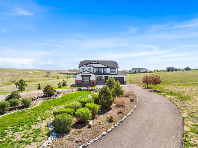 a view of a house with a yard and ocean view