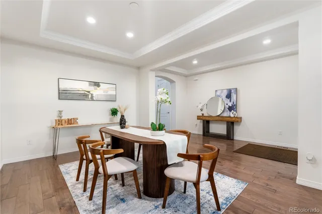 a view of a dining room with furniture and wooden floor