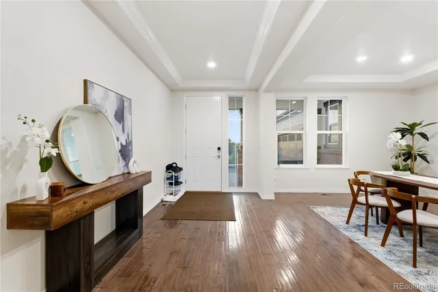 a dining room with furniture and wooden floor