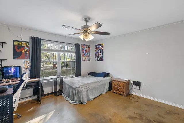 a bedroom with furniture and a ceiling fan