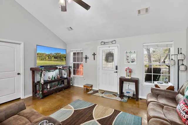 a living room with furniture and a flat screen tv