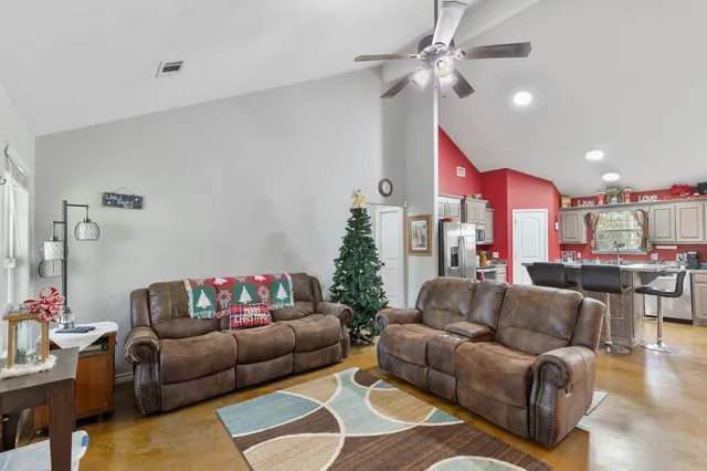a living room with furniture and a chandelier