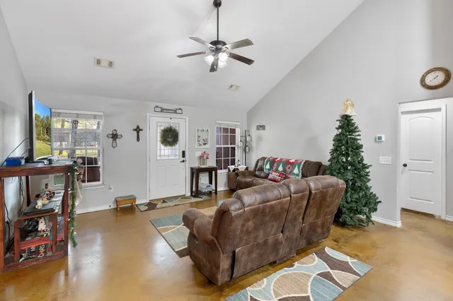 a living room with furniture and a flat screen tv